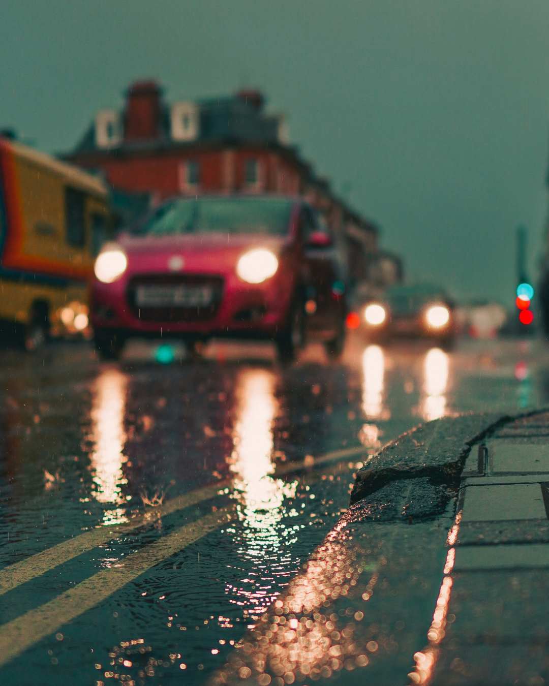 Photo of a car driving down a wet road by Jack Lucas Smith on Unsplash